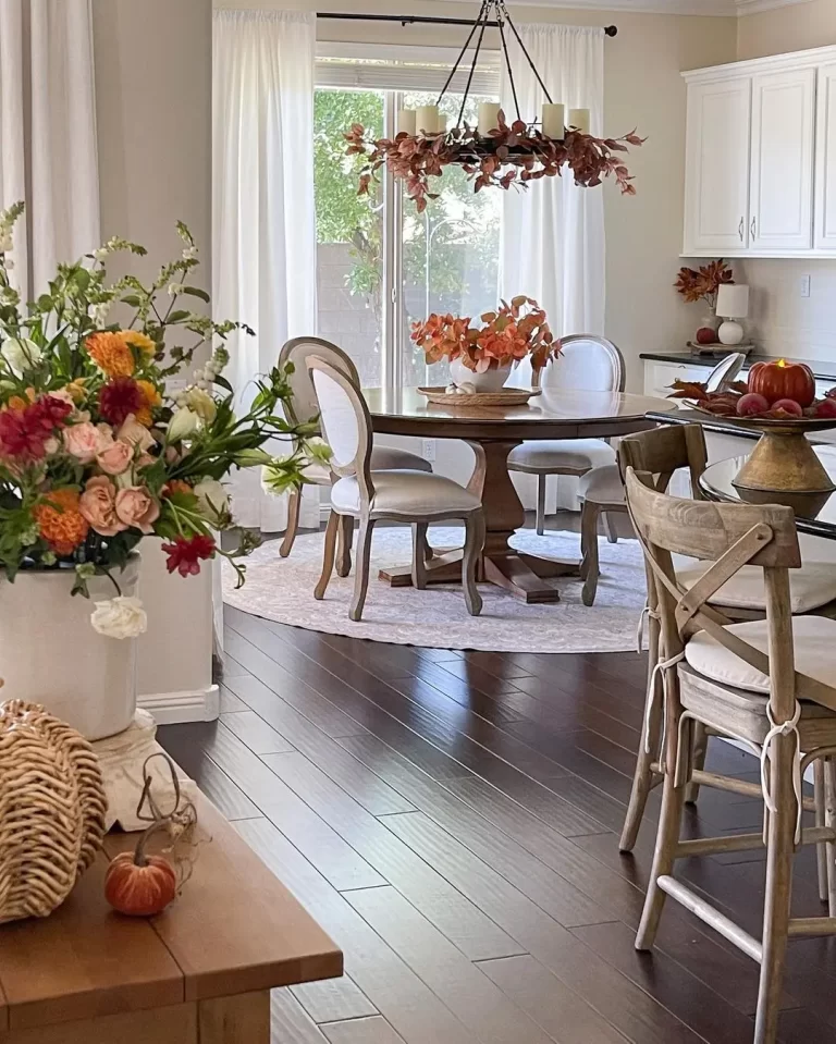 fall stems, fresh and faux florals, pumpkins, and candles are used in this living space to bring seasonal changes to the decor without overwhelming the existing decor.