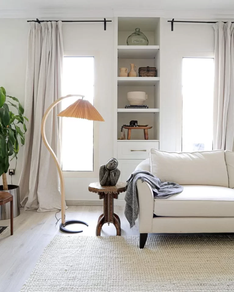 a rental space can easily be personalized by adding decor items that resonate with oneself and by selecting a few important furnishings such as a couch, end table, and floor lamp as in this living room.