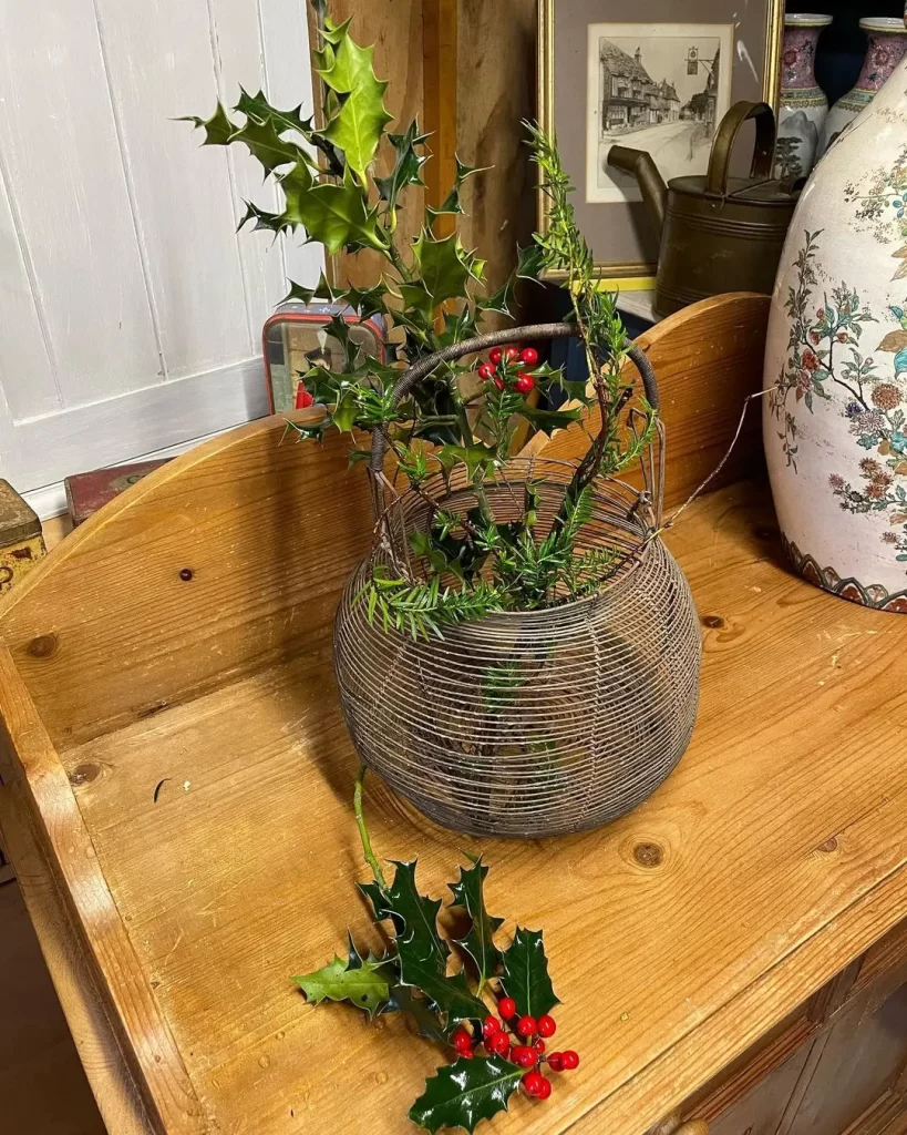 a wire basket is a great accessory to decorate an entryway with flowers.
