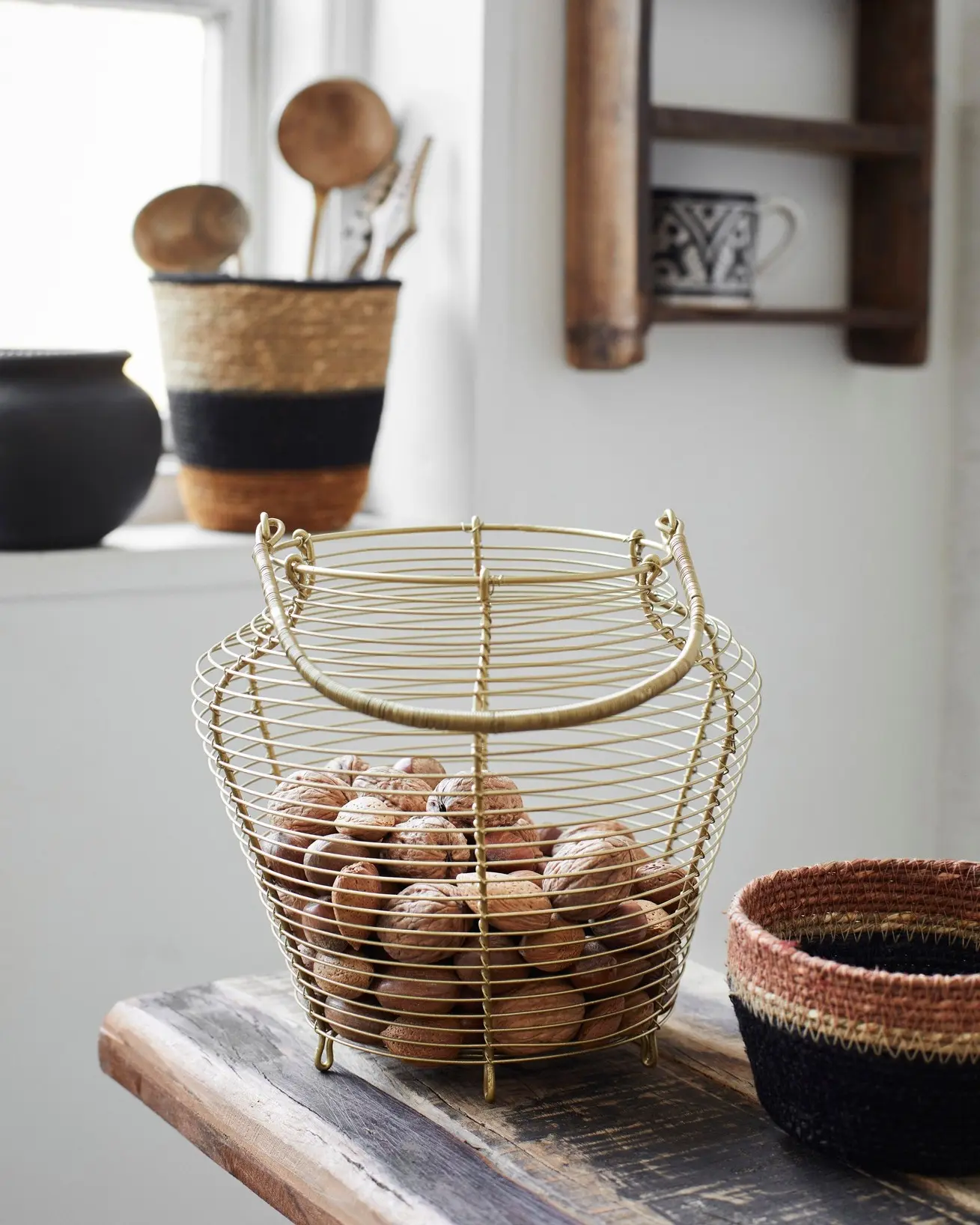 This iron basket with handles makes a perfect container for nuts, fruits and vegetables or other kitchen organization needs.