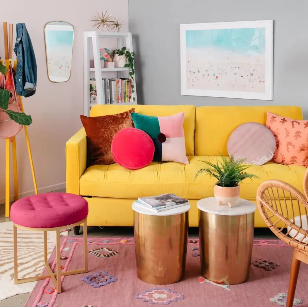 it takes some experimenting to achieve an inspiring funky living room decor like this one using bold colored pillows and couch cover along with layered area rugs.