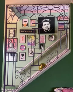 a gallery wall as seen through a stair balustrade adds character and personality to an otherwise blank and often overlooked wall.