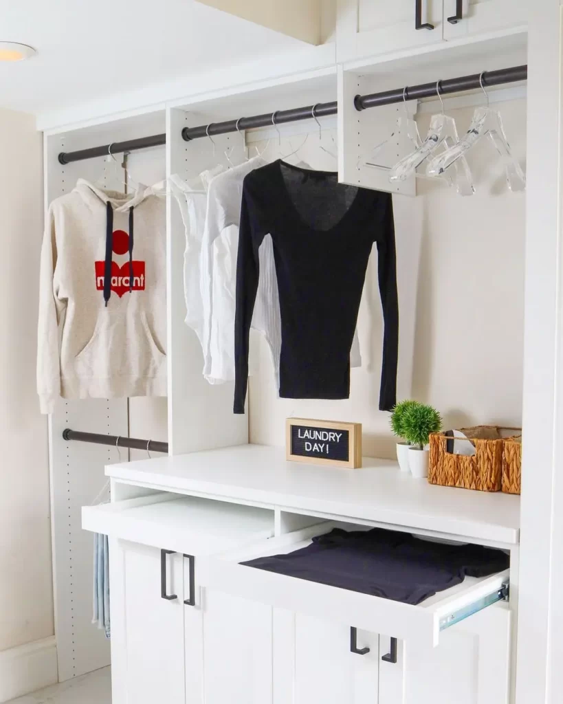 a small laundry room can benefit from a pull out folding station installed within a wall cabinet.