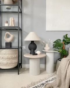 pairing two side tables next to each other can be used to style various items, add visual interest, and functionality to a living space.