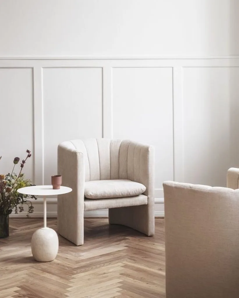 it's important to choose and pair a small side table to a sofa in order to complement the overall decor of a living room rather than to compete with it.