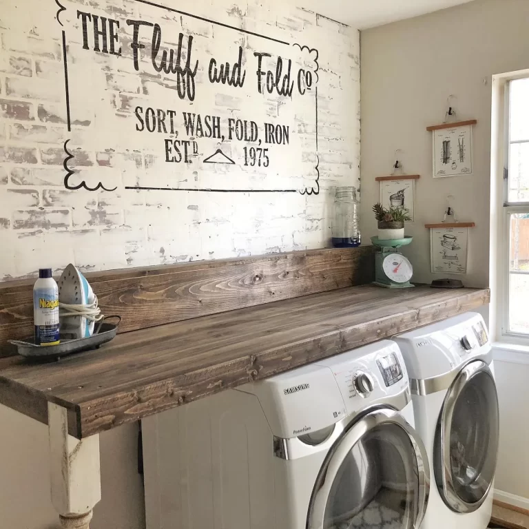 a wooden counter as accent piece with the right finish and details can add a strong vintage feel to your farmhouse style laundry room.