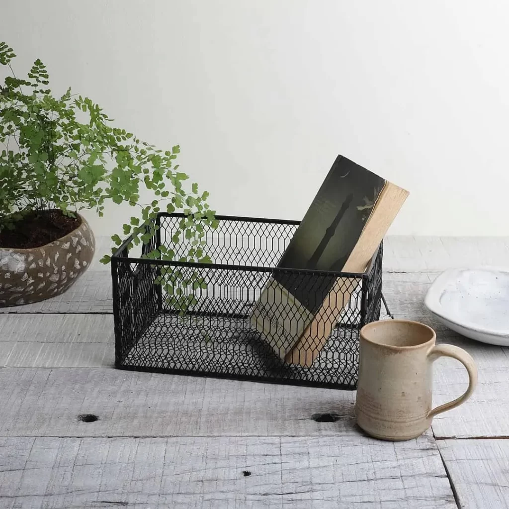 wire basket in an industrial bedroom style is a great accent decor item which doubles as storage for a well organized bedroom.