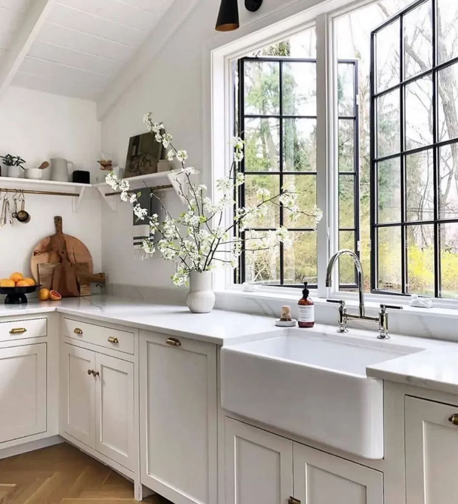 bright color palette, natural elements like a potted plant, and unobstructed openings are some of the ways to easily add summer flair to your kitchen effortlessly.
