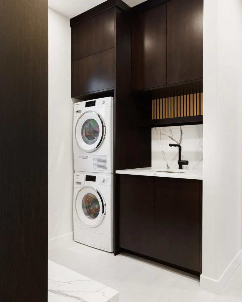 a washer and dryer in a small laundry room with built-in space provides a clean look while saving on space