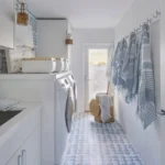 a coastal-inspired laundry with light blue and white color palette and a beautiful woven laundry basket complements the decor by adding texture