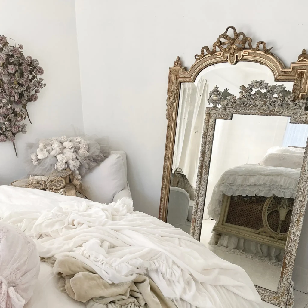 mirrors are great accessories to include in a coquette bedroom decor as it has a magical feel to it as in this bedroom with these antique-framed wall mirrors