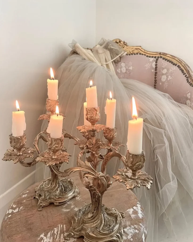 a pair of beautiful candelabras add a touch of elegance and romantic feel to this space with a matching sofa in the background