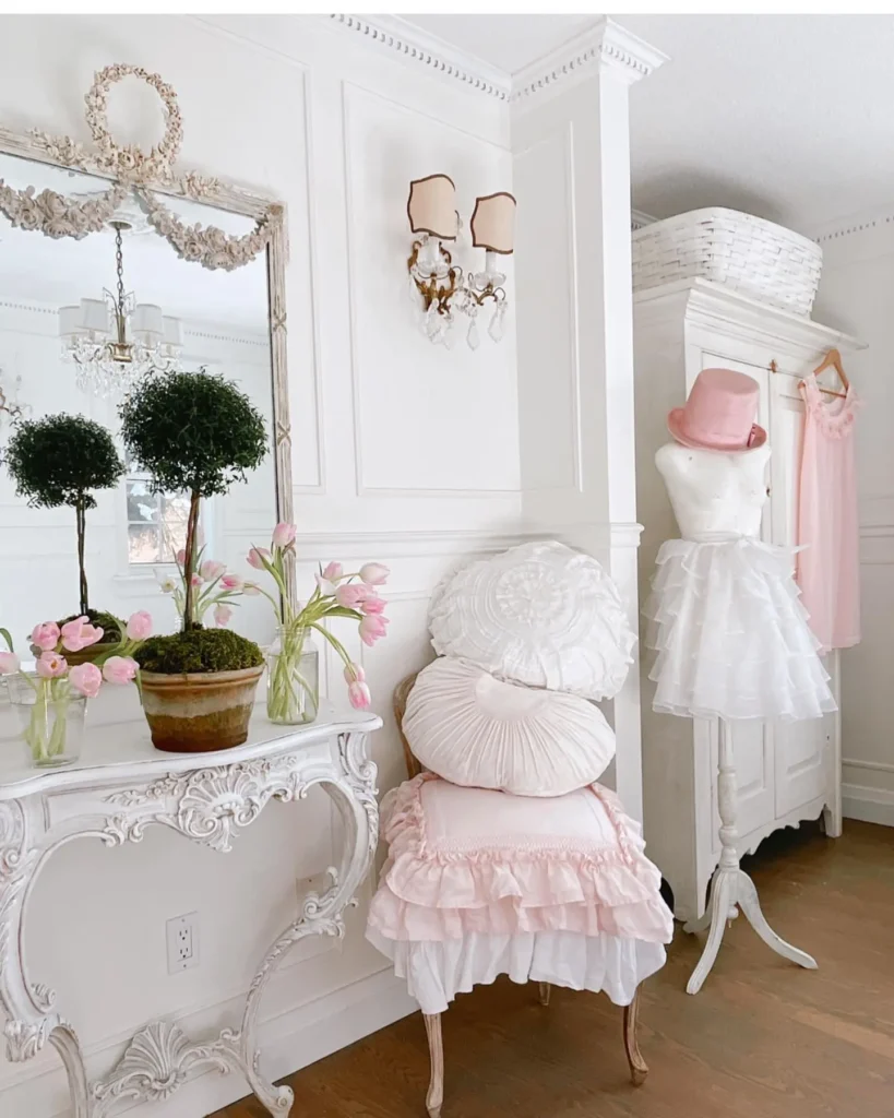 adding textiles to a coquette-styled bedroom can be achieved in various ways such as using pillows or hanging dress on the wall as in this romantic-looking bedroom