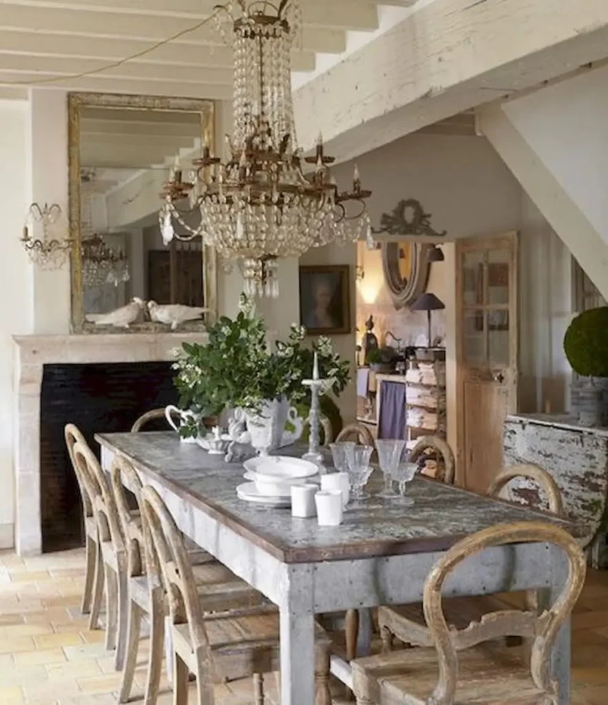 french country dining room with elegant ceiling chandelier and rustic table and chairs bring warmth and nostalgia to this space