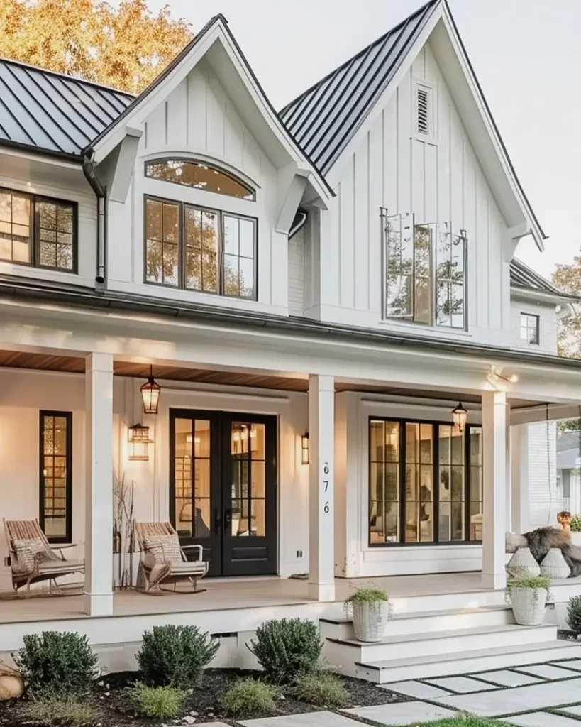 front porch of a white farmhouse with ambient lights on during daytime