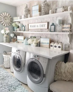 a laundry room with countertop and coastal inspired decor elements such as wall art, jars, and florals