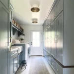 a mudroom that incorporate a laundry can make a great combo for efficiency and creative design opportunities as with the blue painted cabinets on both sides of this room
