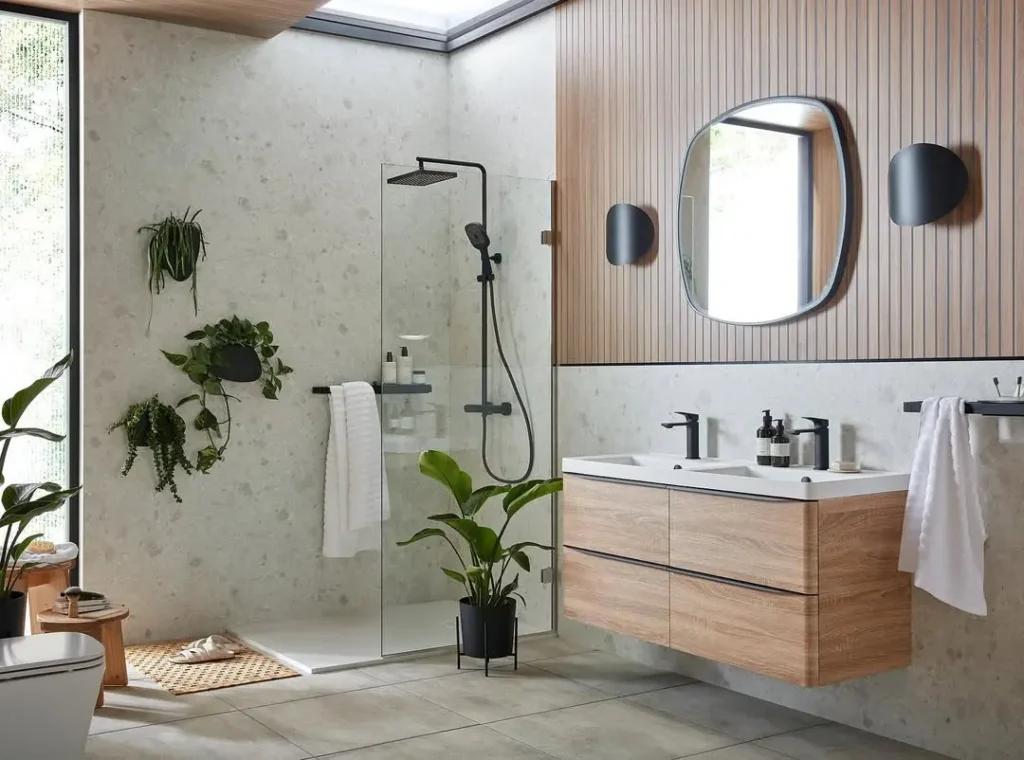 Organic Modern Bathroom with wood accents, glass shower, wall-mounted sink cabinet, large mirror, potted plants, and ample natural light from a skylight.