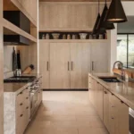 earthy tone make this kitchen warm and cozy to be in thanks to the extensive use of wood and and earthy color palette with matching hardware