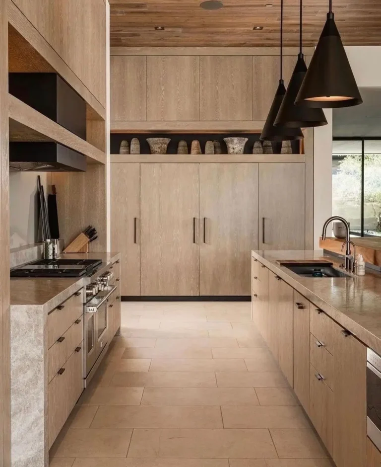earthy tone make this kitchen warm and cozy to be in thanks to the extensive use of wood and and earthy color palette with matching hardware