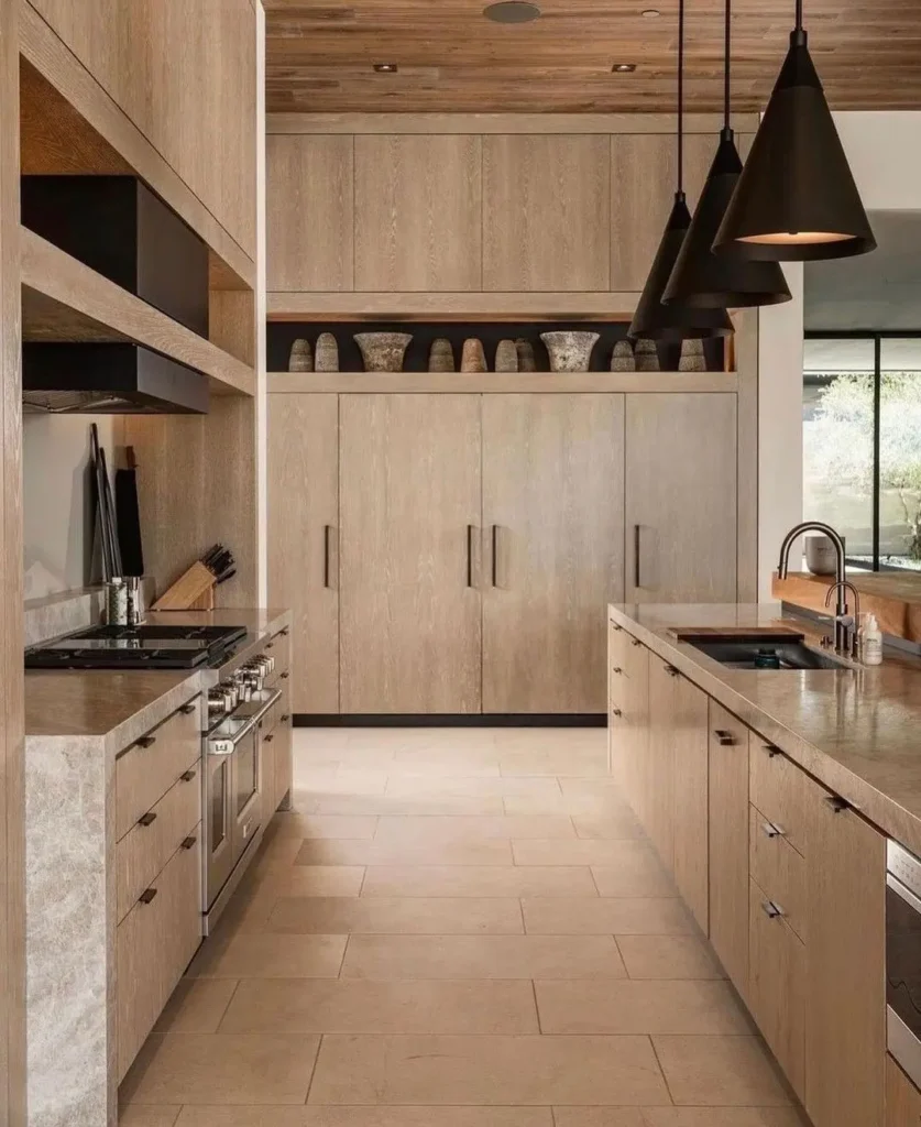 earthy tone make this kitchen warm and cozy to be in thanks to the extensive use of wood and and earthy color palette with matching hardware