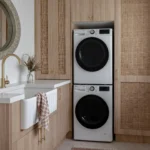 a laundry room that uses every inch with stacked appliances, ample wall cabinet along with a laundry sink make this space a pleasure to do laundry in