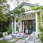 patio decor with a coastal-inspired style can easily be obtained with just a few outdoor furniture and works great as in this open backyard space