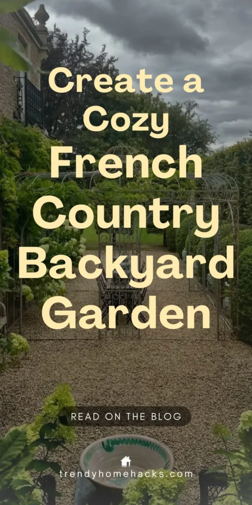 Overlay text: ‘Create a Cozy French Country Backyard Garden’ appears over a gravel path leading to a wrought iron bench framed by lush greenery and arched trellises in a vintage-style French country garden.
