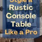 Rustic console table styled in a hallway with natural wood texture, layered mirrors, greenery, and decorative accents. Text overlay reads “How to Style a Rustic Console Table Like a Pro.”