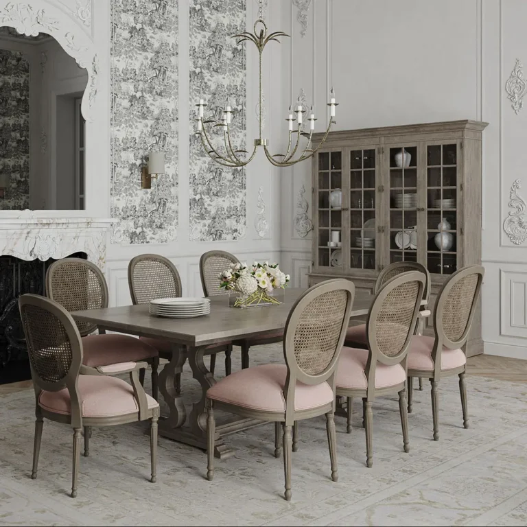 A formal dining room with a rectangular wooden table, eight pink cushioned chairs, a floral centerpiece, and a chandelier blends French country decor with other styles, complemented by a glass-front cabinet and decorative wall molding.