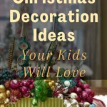 A colorful tabletop Christmas display featuring shiny ornaments in pink, gold, red, and green, arranged in a green ceramic container. The image includes overlay text that reads: “10+ Christmas Decoration Ideas Your Kids Will Love.”