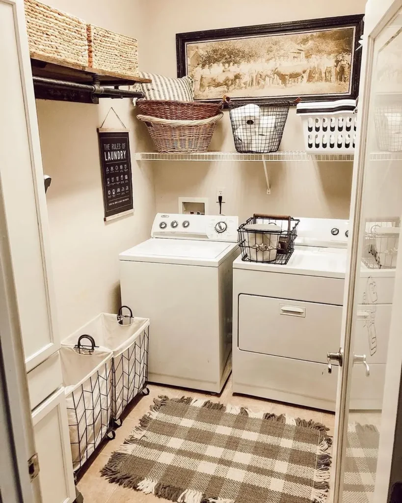 A small farmhouse laundry room with a washer and dryer, wire baskets for organizing, a plaid rug, shelves with storage bins, and a wall art piece above the appliances, showcasing creative ways to use wire baskets in your farmhouse decor.