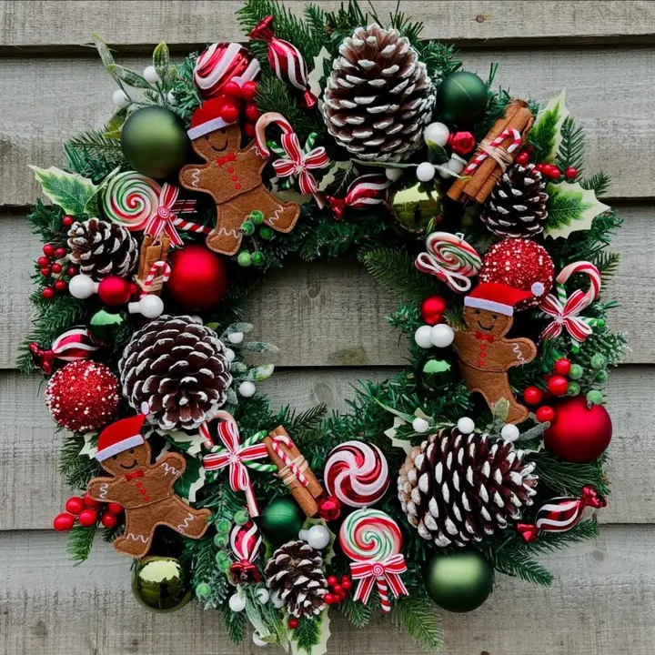 Festive Christmas entryway wreath made with pinecone, candy cane ornaments, green and red baubles, and holiday greenery for a warm, welcoming look.