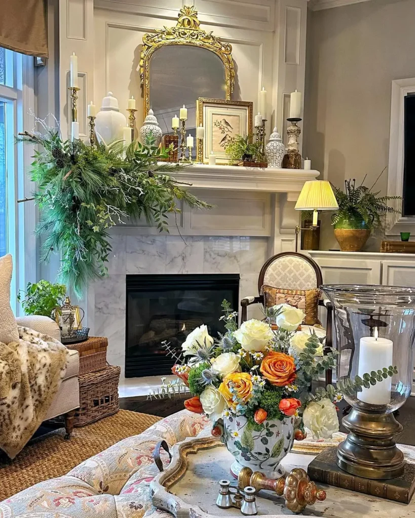 Elegant living room with marble fireplace, floral arrangements, ornate mirror, candles, and classic furnishings. Cozy, well-lit, and decorated for winter with greenery and vintage accessories.