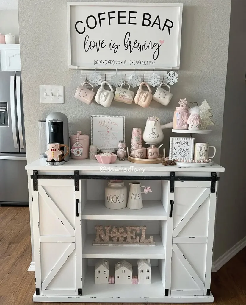 A white christmas coffee bar setup with mugs, coffee maker, festive holiday decorations, canisters, and a charming sign reading "COFFEE BAR love is brewing.