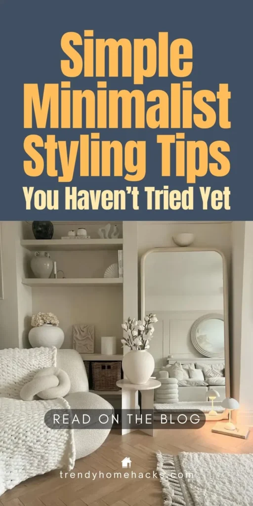 Minimalist living room with neutral decor, cozy textured blankets, a sculptural vase, shelves styled with simple objects, and a large mirror reflecting a serene, clutter-free space.