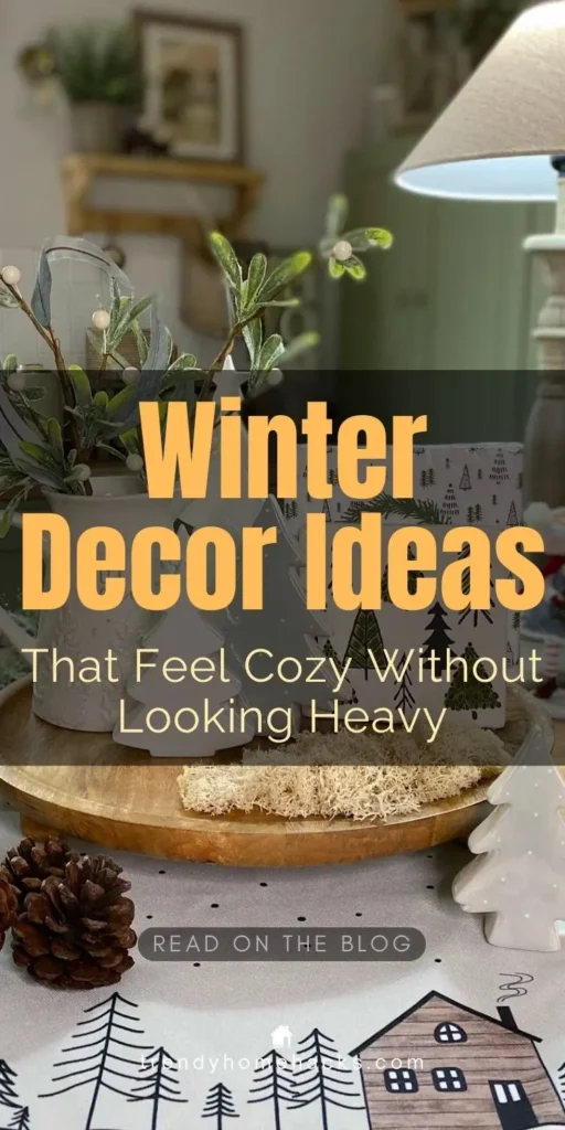 Cozy neutral winter decor with layered textiles, soft greenery, ceramic trees, and warm lighting styled on a tabletop for after Christmas winter decorating.