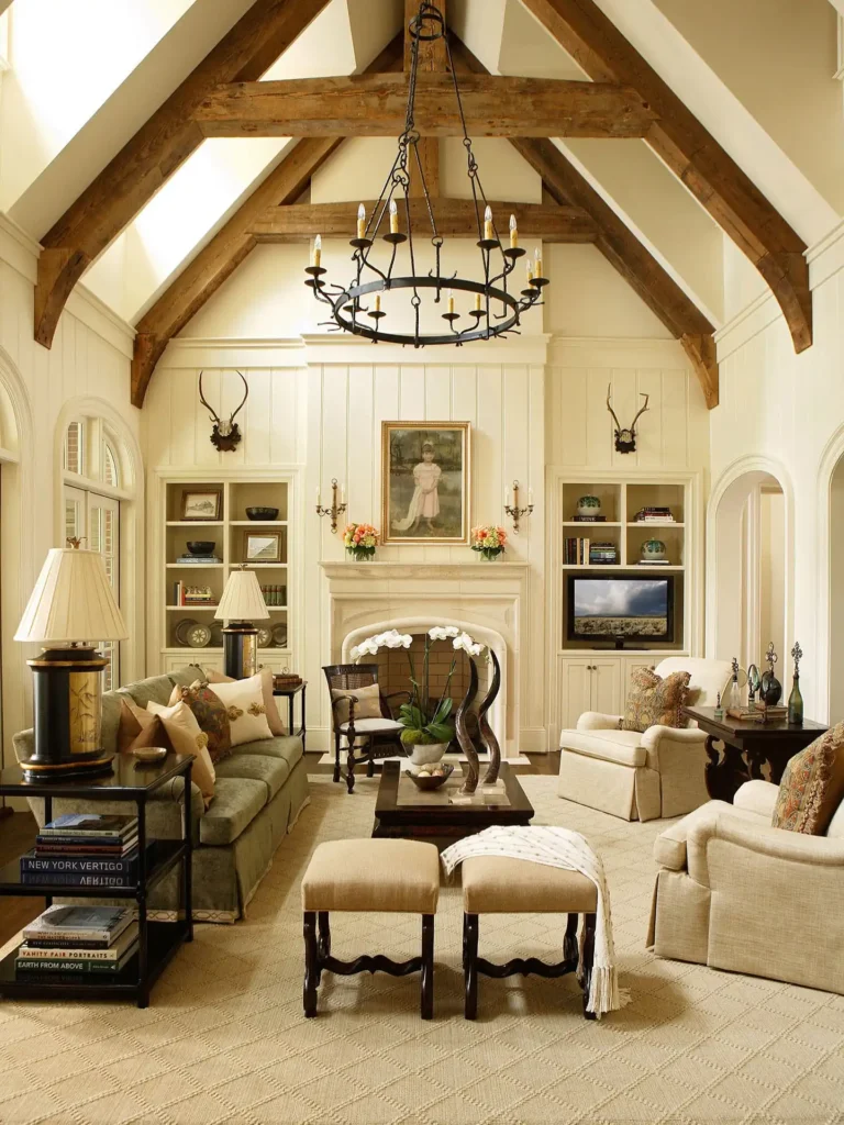 Spacious living room with rustic vaulted wood beam ceiling, chandelier, beige furniture, fireplace, built-in shelves, and decorative art above the mantel.